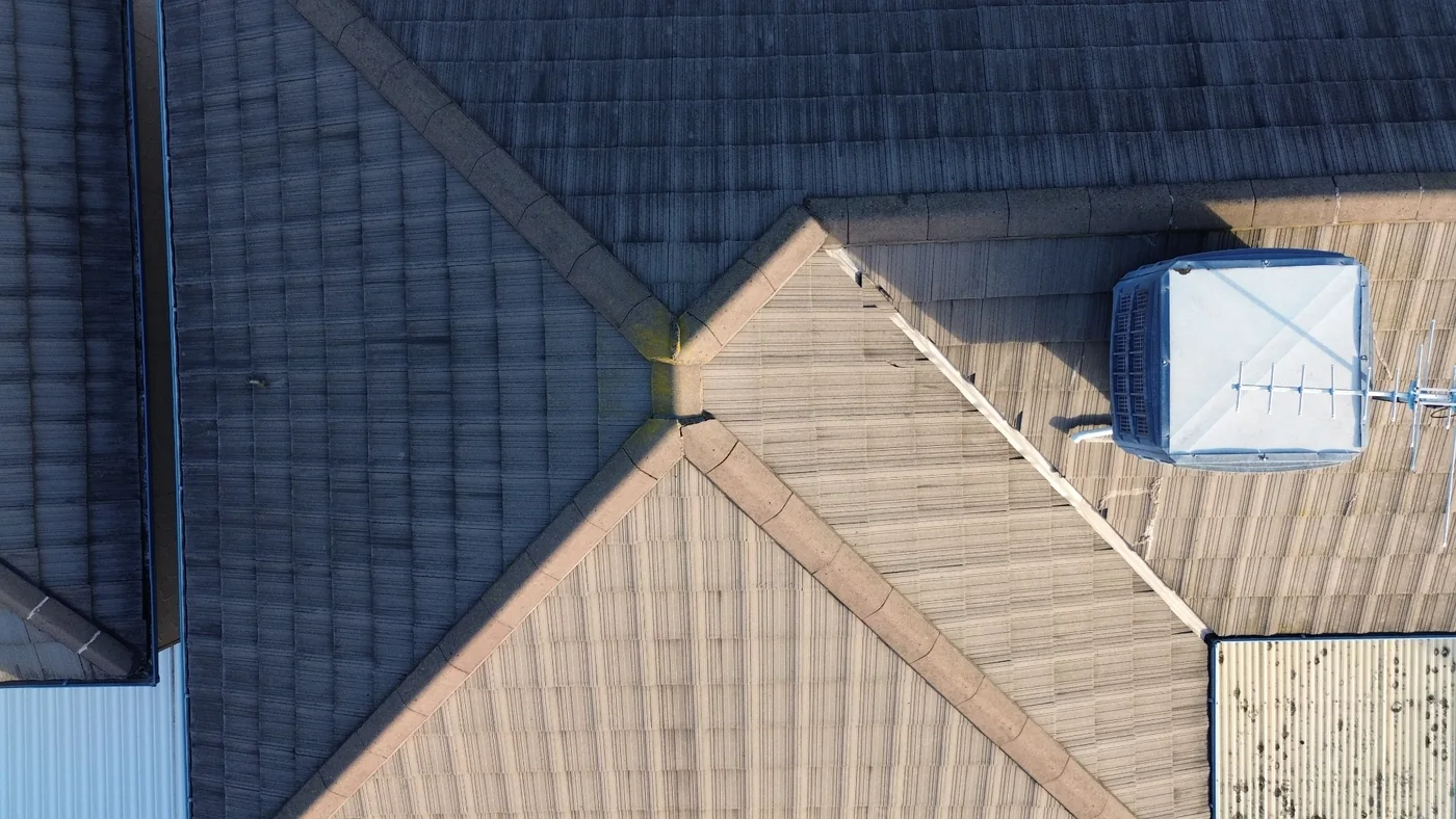 Overhead roof view showing multiple roof planes and a rooftop unit