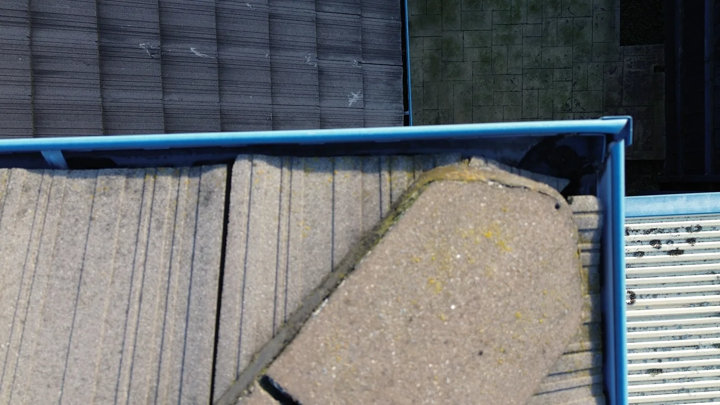 Closer overhead view of a roof edge and adjacent guttering