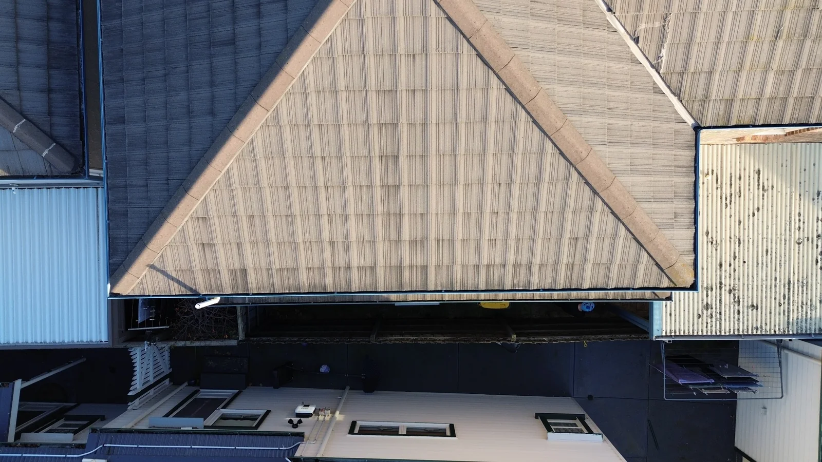 Wide overhead drone photograph of a tiled residential roof